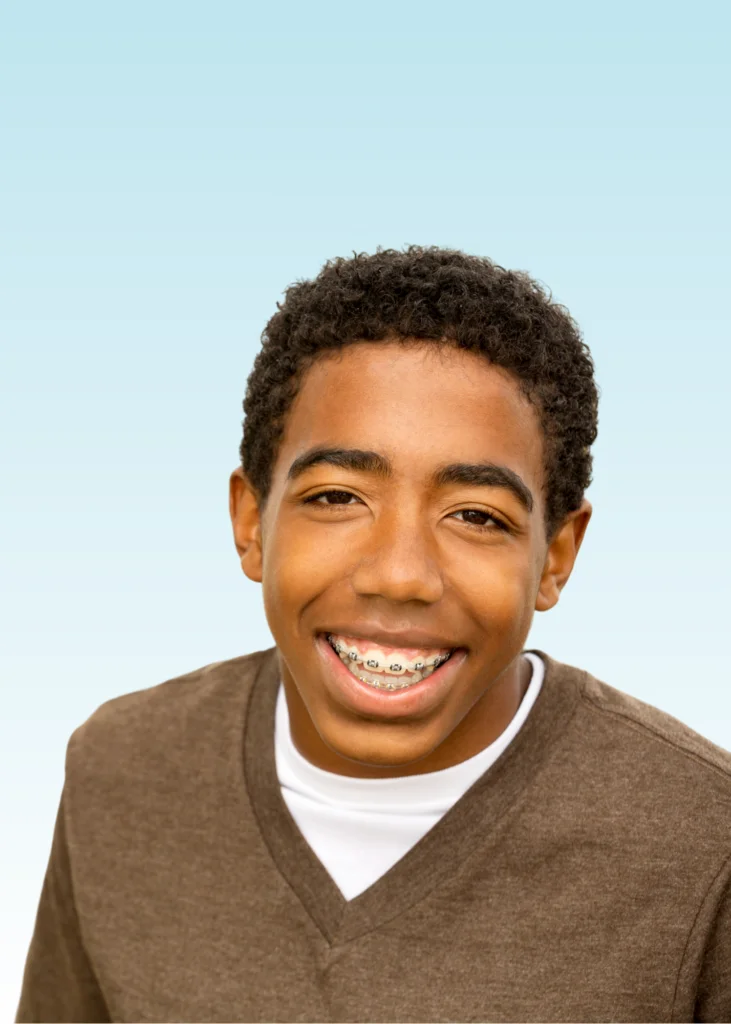 Smiling teen boy with metal braces wearing a brown V-neck shirt