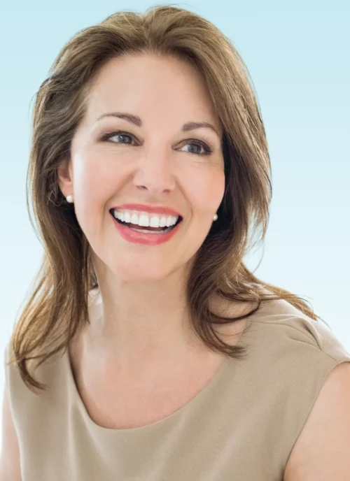 Smiling woman with brown hair showing straight white teeth